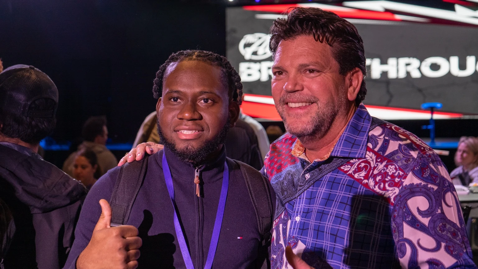 Two attendees posing together at a Breakthrough event
