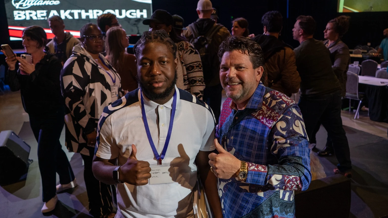 Two attendees smiling at a Breakthrough event