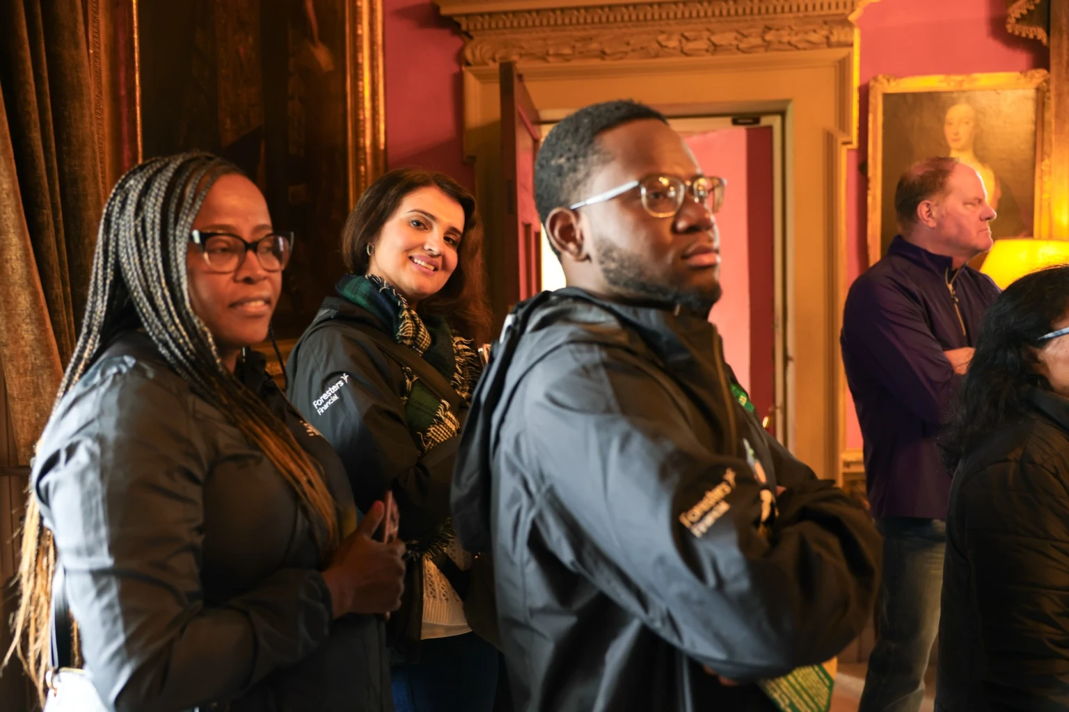 Team members listening together during a group visit