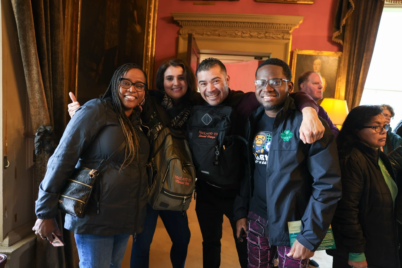 Four attendees posing together during a group visit