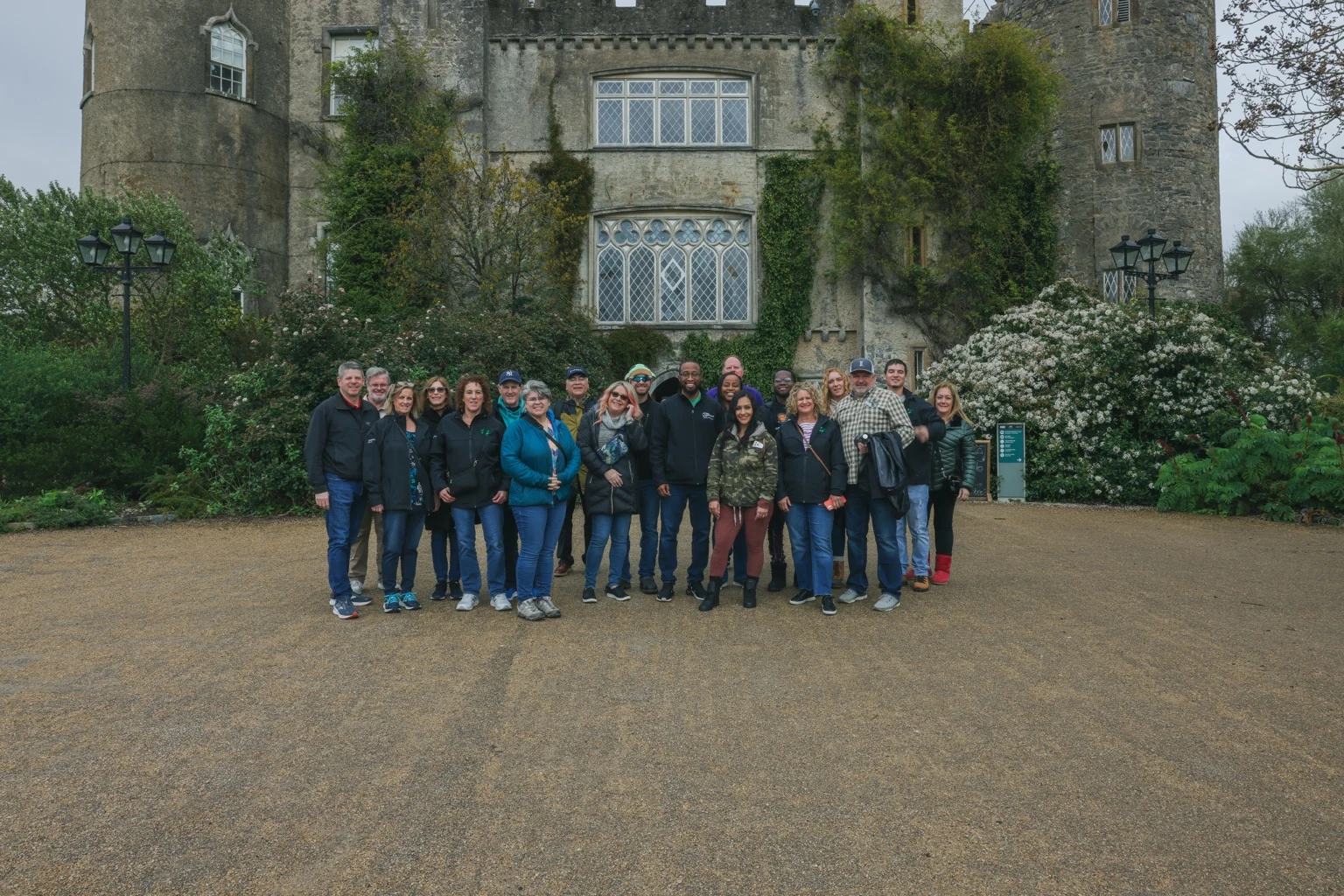 The team gathered in front of a historic stone building